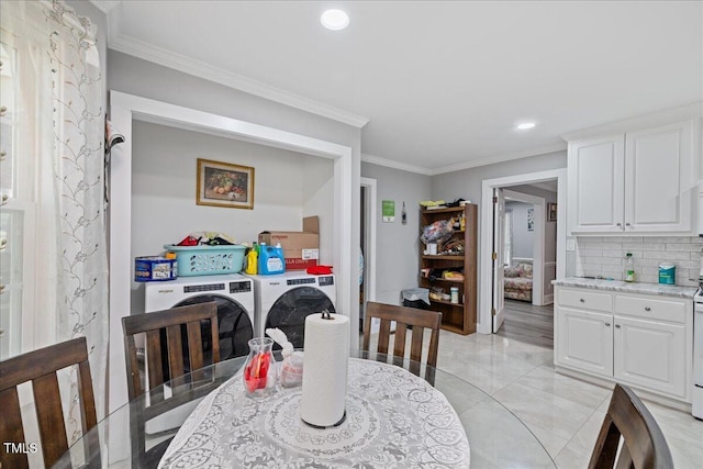 dining room featuring crown molding and washing machine and clothes dryer