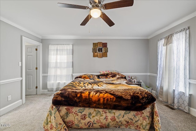 carpeted bedroom with ceiling fan and crown molding