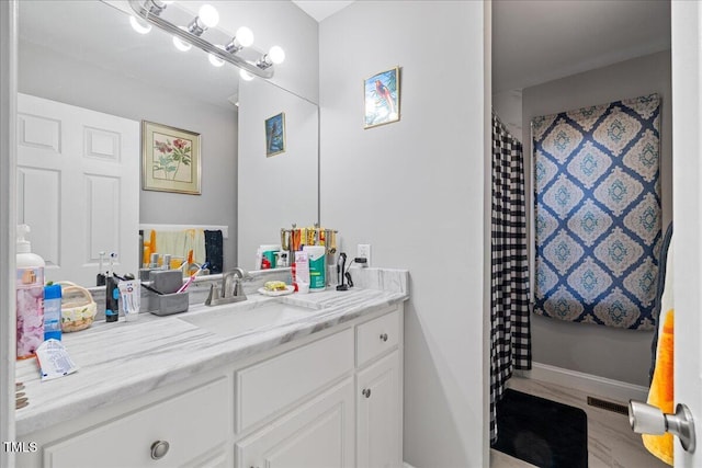 bathroom featuring wood-type flooring and vanity