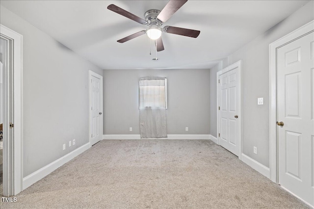 unfurnished room with ceiling fan and light colored carpet