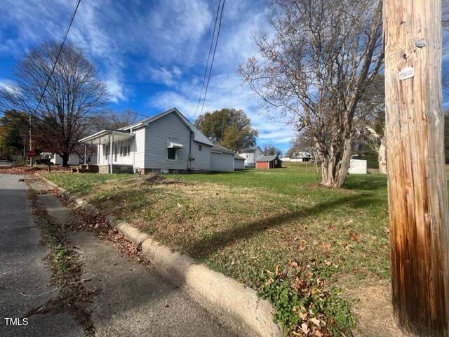 view of side of home featuring a lawn