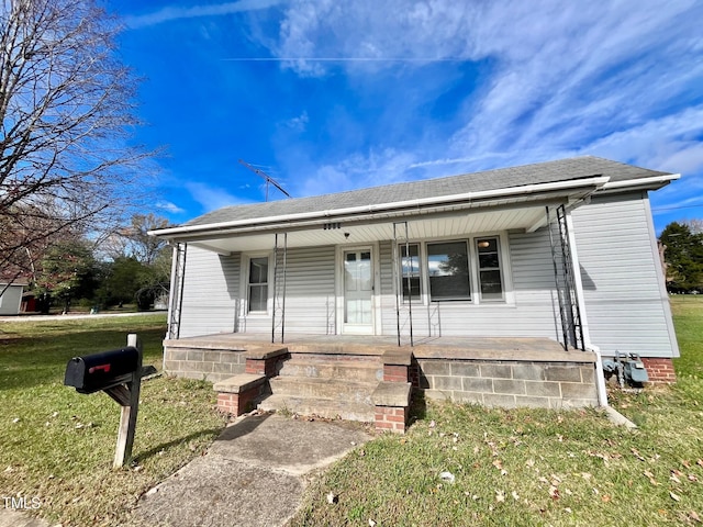 view of front of house with a porch and a front yard