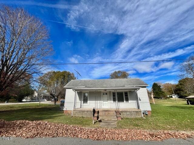 bungalow-style house with a front yard and a porch