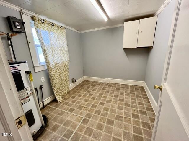 laundry area featuring cabinets, crown molding, and water heater