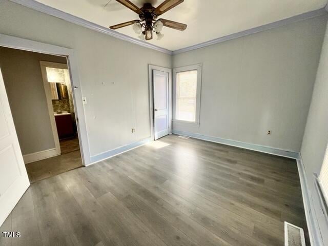 unfurnished bedroom featuring hardwood / wood-style flooring, ceiling fan, and crown molding