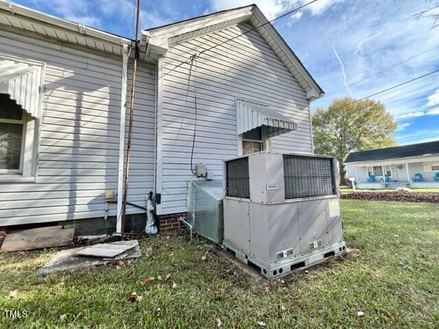 view of side of home with a yard