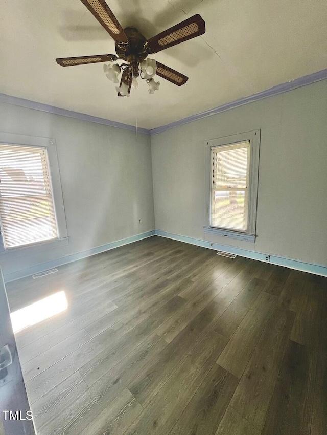 spare room featuring wood-type flooring, ceiling fan, and crown molding