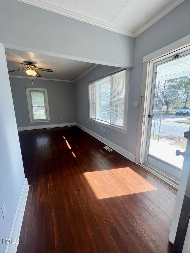 interior space with dark hardwood / wood-style flooring, ceiling fan, and ornamental molding