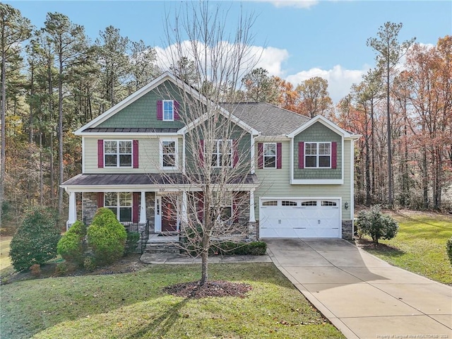 view of front of property with a front lawn, covered porch, and a garage