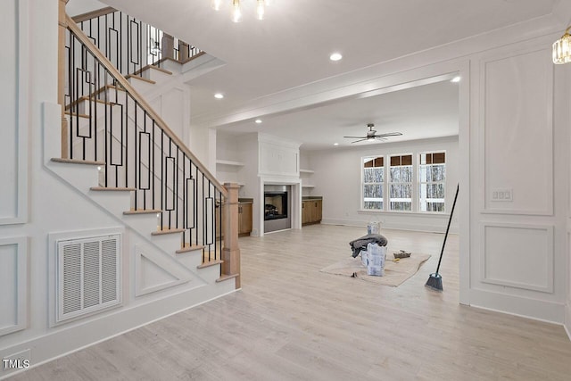 workout room featuring ceiling fan and hardwood / wood-style flooring