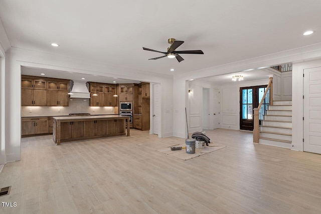 living room featuring ceiling fan and light hardwood / wood-style floors