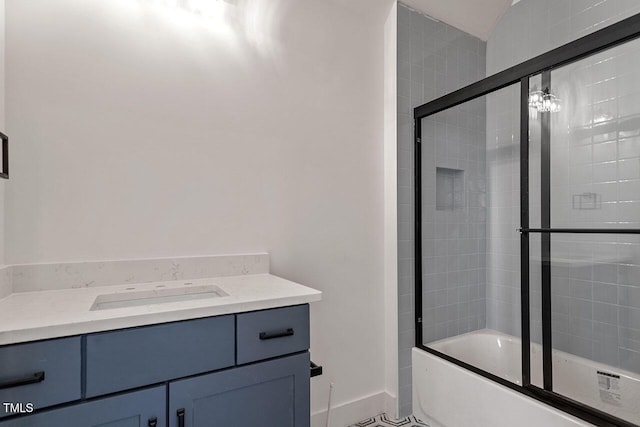 bathroom with combined bath / shower with glass door, tile patterned floors, and vanity