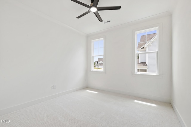 spare room featuring a ceiling fan, carpet floors, and baseboards