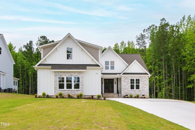 modern inspired farmhouse with board and batten siding, a front lawn, roof with shingles, and driveway