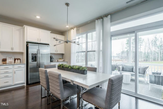 dining space with dark hardwood / wood-style floors