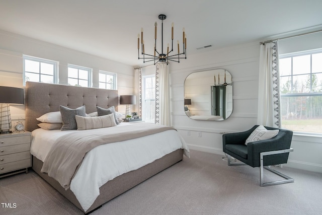 bedroom with carpet flooring, multiple windows, and a chandelier