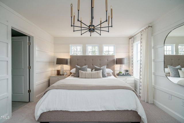 carpeted bedroom with a notable chandelier, crown molding, and multiple windows