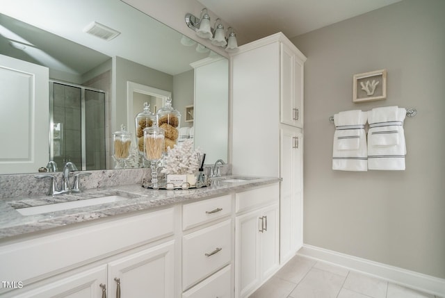 bathroom featuring tile patterned flooring, vanity, and an enclosed shower