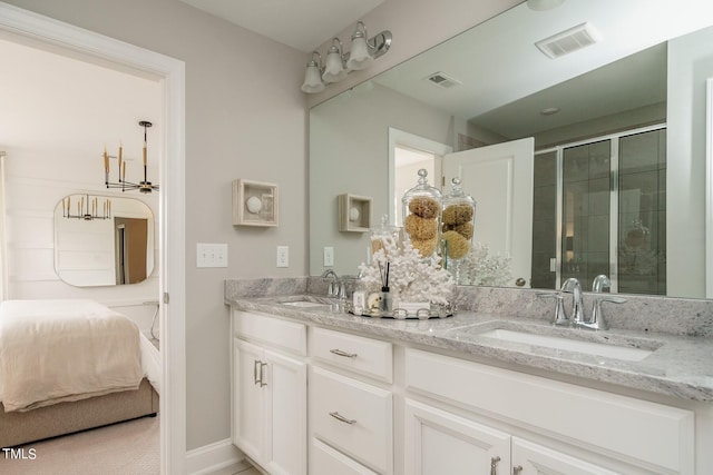 bathroom featuring vanity and a shower with shower door