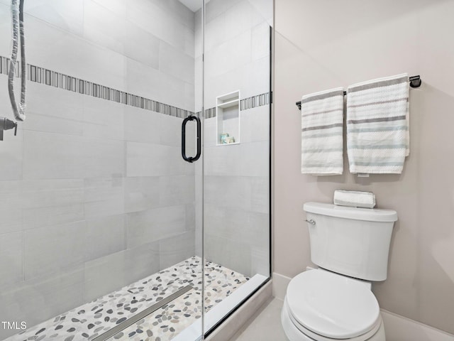 bathroom featuring toilet and walk in shower