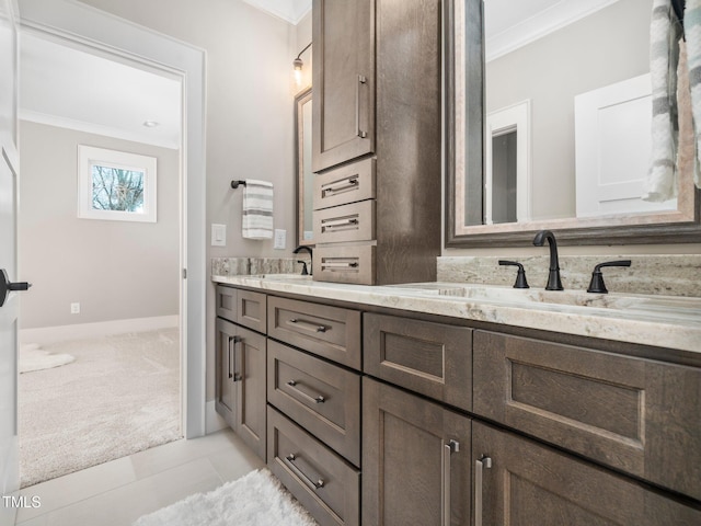 bathroom featuring crown molding, tile patterned flooring, and vanity