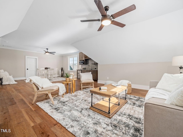 living room with ceiling fan, hardwood / wood-style floors, and sink