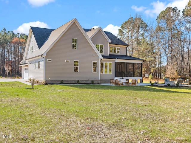 back of house with a lawn, an outdoor living space, a patio, and a garage