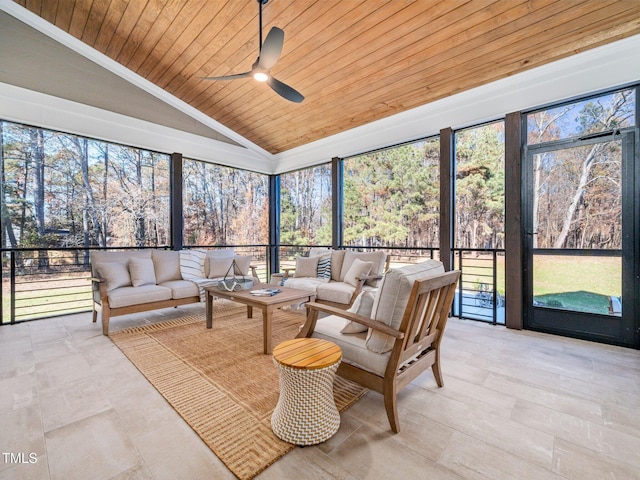 sunroom featuring vaulted ceiling, ceiling fan, and wood ceiling