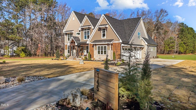 145 Wiggins Rd, Louisburg, NC 27549 - craftsman inspired home featuring concrete driveway, an attached garage, roof with shingles, stone siding, and a standing seam roof