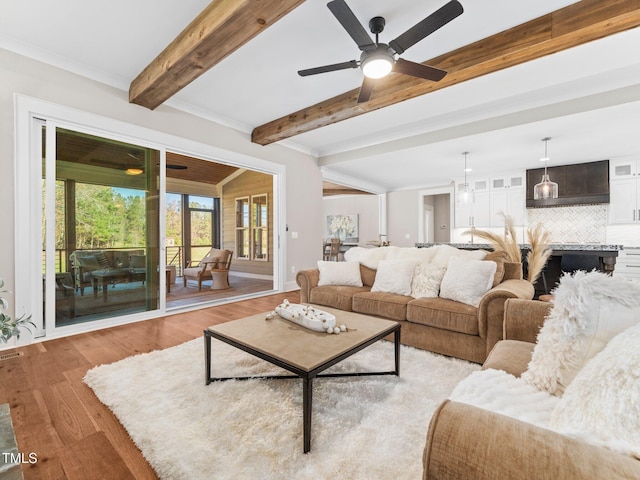 145 Wiggins Rd, Louisburg, NC 27549 - living room featuring light wood-style floors, ceiling fan, and beam ceiling