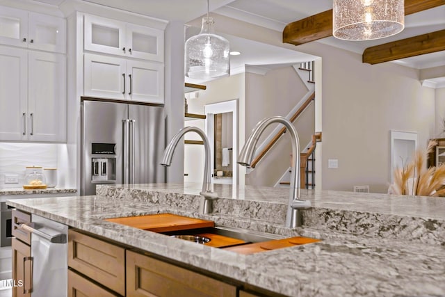 145 Wiggins Rd, Louisburg, NC 27549 - kitchen featuring high end fridge, beam ceiling, light stone countertops, glass insert cabinets, and white cabinets