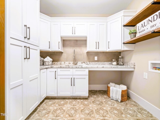 145 Wiggins Rd, Louisburg, NC 27549 - washroom featuring washer hookup, cabinet space, and light tile patterned floors