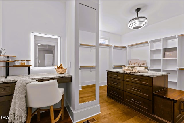 spacious closet featuring light hardwood / wood-style flooring