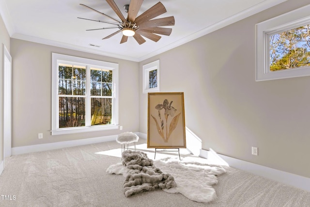 sitting room featuring carpet flooring, ceiling fan, and ornamental molding