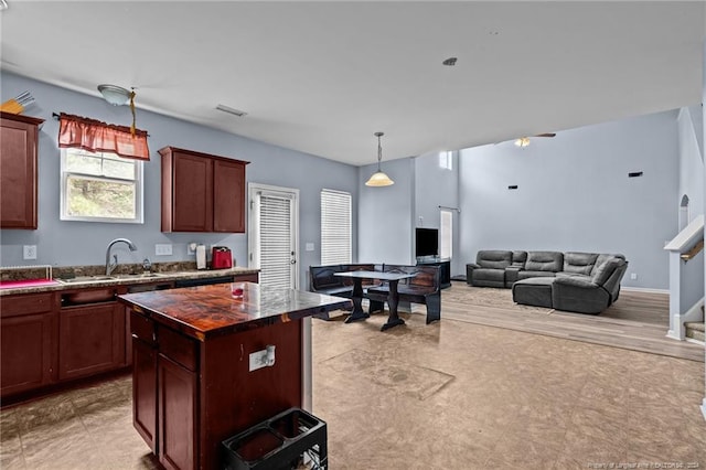 kitchen featuring a center island, pendant lighting, and sink