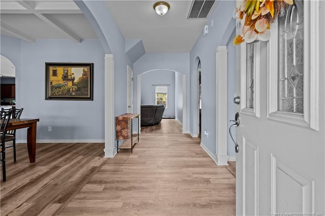 hallway with beamed ceiling, light wood-type flooring, and coffered ceiling