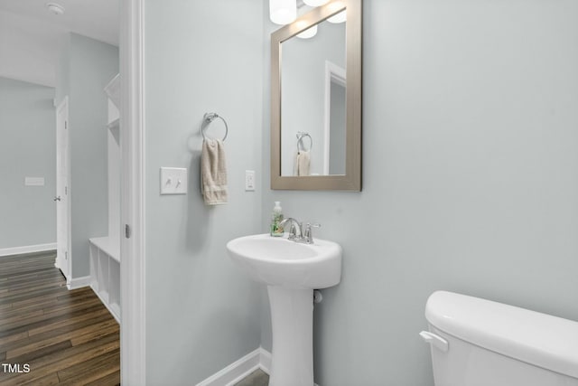 bathroom featuring hardwood / wood-style floors, toilet, and sink