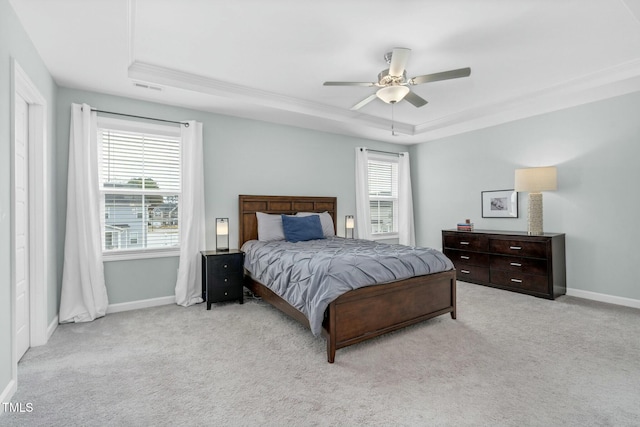 bedroom featuring multiple windows, light carpet, and ceiling fan