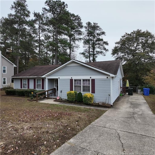 single story home featuring concrete driveway