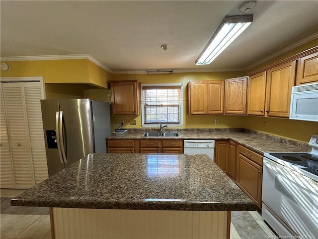 kitchen with ornamental molding, a kitchen island, a sink, dark stone countertops, and white appliances