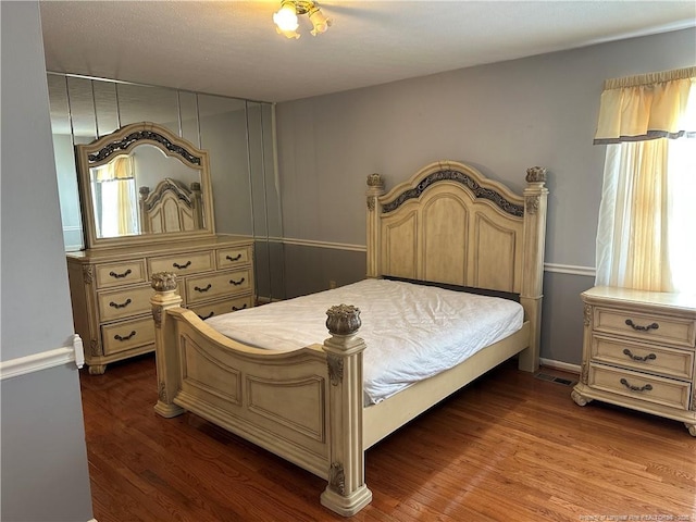 bedroom featuring dark wood-style floors