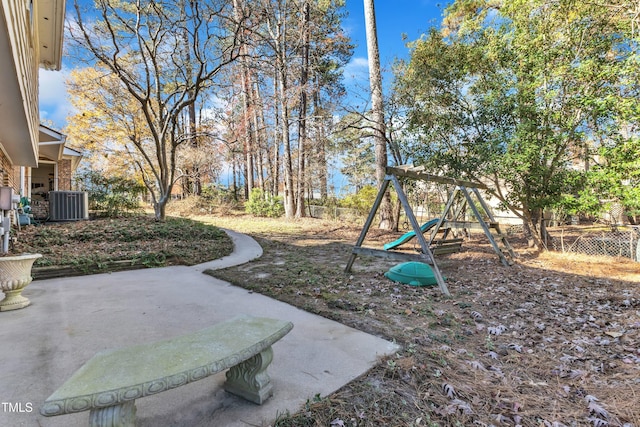 view of yard with a playground, cooling unit, and a patio