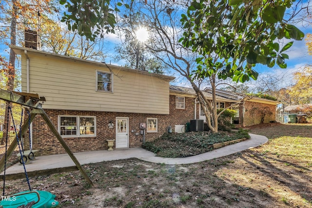 back of property featuring cooling unit and a patio