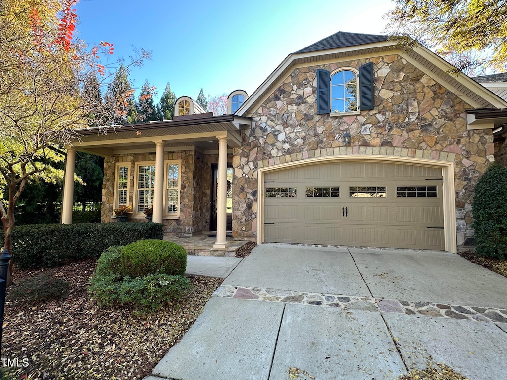 view of front of property featuring covered porch and a garage