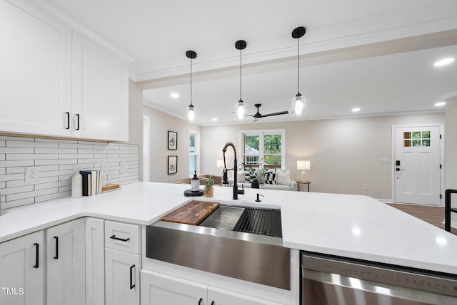 kitchen featuring decorative backsplash, white cabinetry, dishwasher, and sink