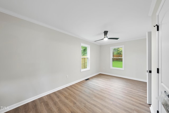 empty room with light wood-type flooring, ceiling fan, and crown molding