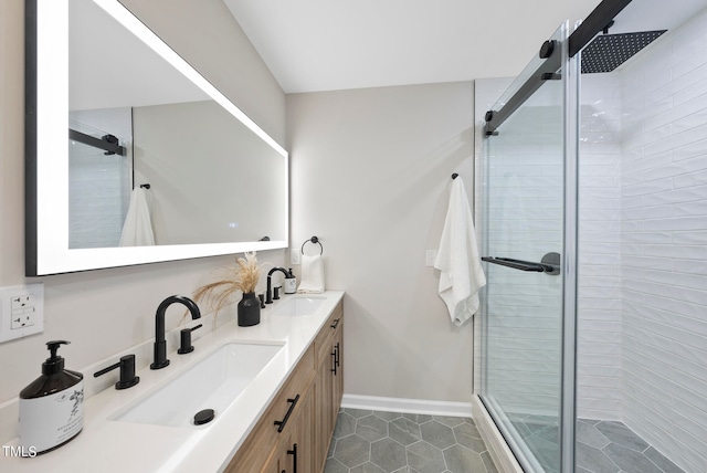 bathroom featuring tile patterned flooring, vanity, and an enclosed shower