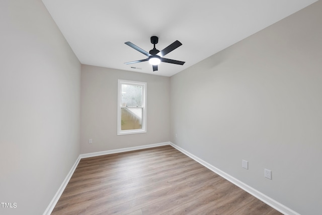 unfurnished room with ceiling fan and light wood-type flooring