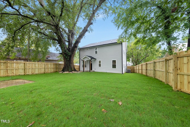 rear view of property with a lawn