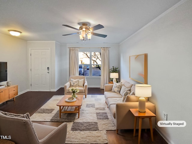 living room with dark hardwood / wood-style flooring, ceiling fan, and crown molding